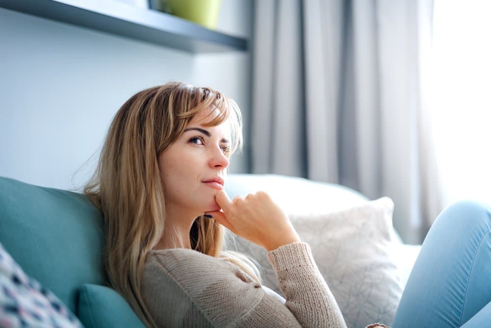 Woman thinking about How Old Do You Have to Be to Get a BBL