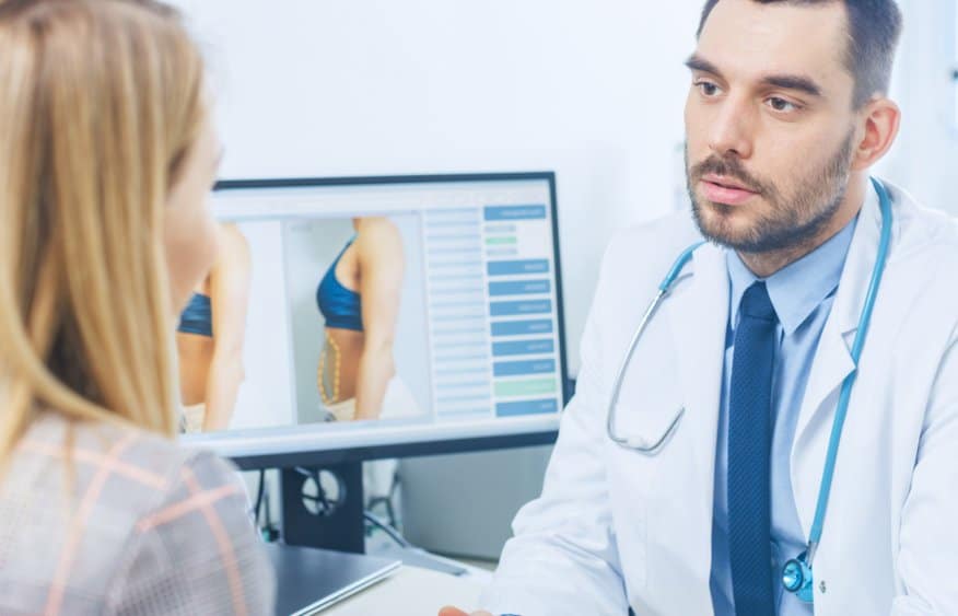 Doctor talking to patient about Vaser liposuction pros and cons​