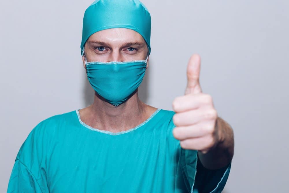 Surgeon showing thumbs up
